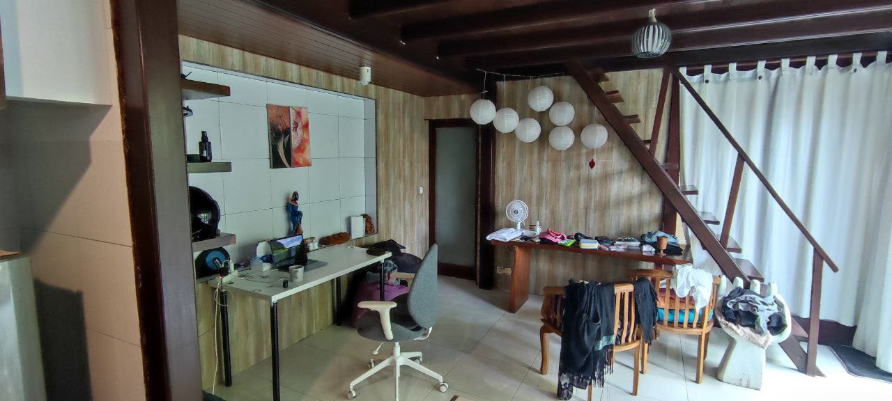 Ground floor with work tables and a staircase