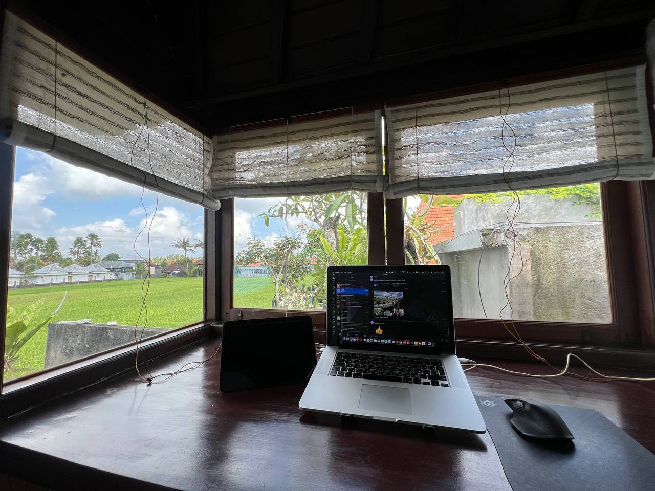 A workspace at a panoramic window overlooking the rice fields